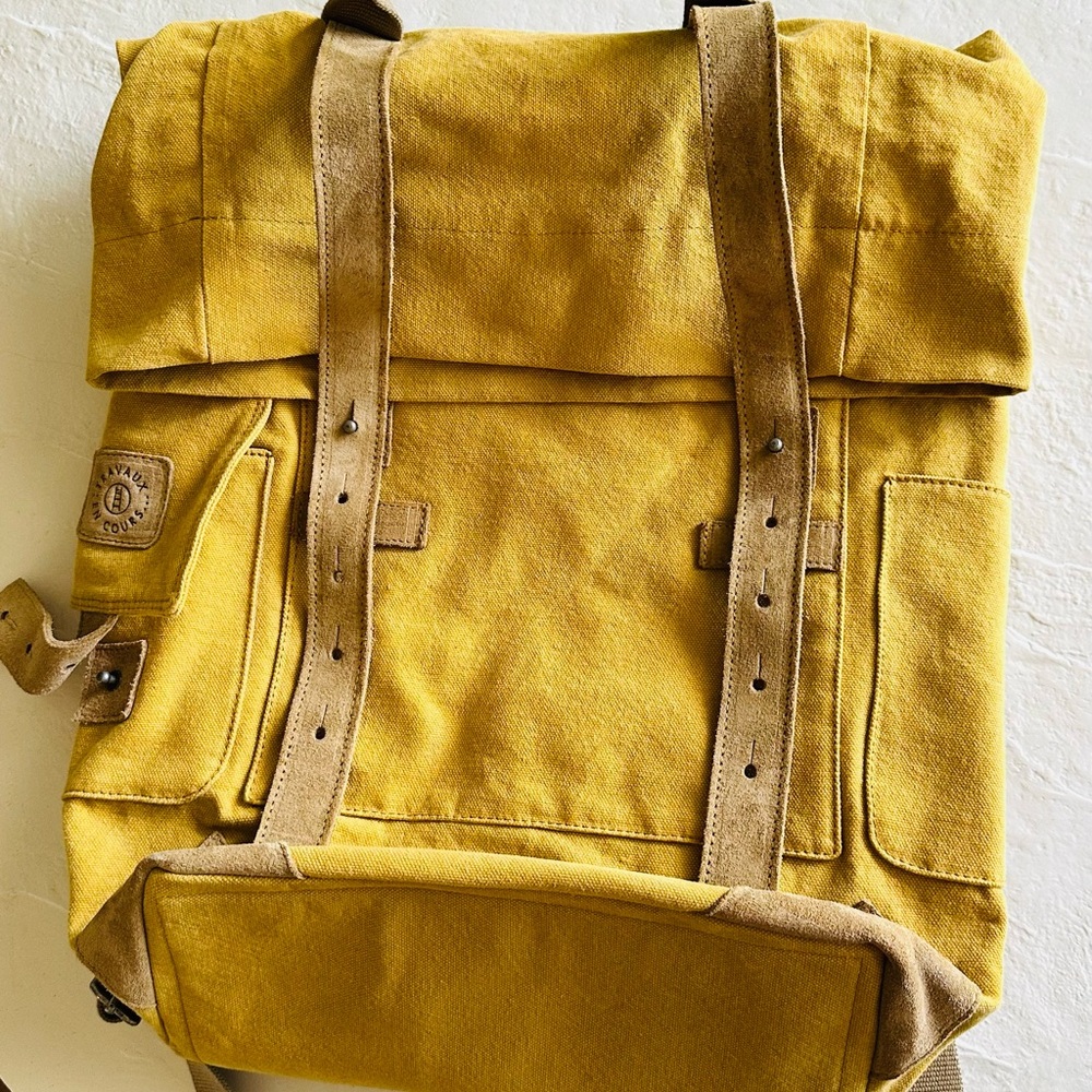 Tannish yellow fold over backpack made -heavy duty fabric,  tan suede accents